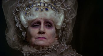 Movie still from “Fellini's Casanova” (1976), directed by Federico Fellini – An old woman with a white wig wearing a crown; Close Up shot, High angle