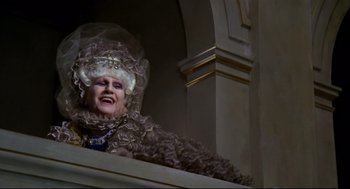 Movie still from “Fellini's Casanova” (1976), directed by Federico Fellini – An older woman dressed in a wig and a dress; Medium shot, Low angle