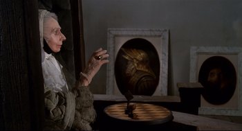Movie still from “Fellini's Casanova” (1976), directed by Federico Fellini – An old woman sitting in front of a chessboard; Close Up shot, High angle