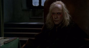 Movie still from “Fellini's Casanova” (1976), directed by Federico Fellini – A man with a long white hair sitting in a chair; Medium shot, Over the shoulder angle