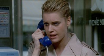 Movie still from “Femme Fatale” (2002), directed by Brian De Palma – A woman holding a phone to her ear; Close Up shot, High angle