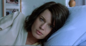 Movie still from “Femme Fatale” (2002), directed by Brian De Palma – A person laying in bed; Close Up shot, High angle