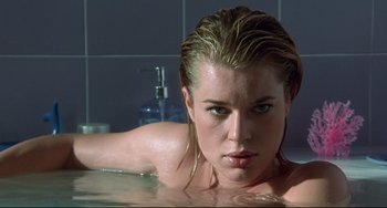 Movie still from “Femme Fatale” (2002), directed by Brian De Palma – A beautiful young woman with wet hair laying in a tub; Close Up shot, Low angle