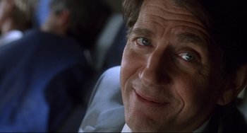 Movie still from “Femme Fatale” (2002), directed by Brian De Palma – A person wearing a white shirt and tie; Close Up shot, Low angle