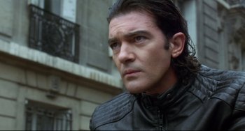 Movie still from “Femme Fatale” (2002), directed by Brian De Palma – A person with long hair; Close Up shot, Low angle