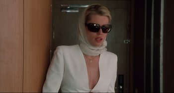Movie still from “Femme Fatale” (2002), directed by Brian De Palma – A woman wearing a white jacket and a white head scarf; Medium shot, Low angle