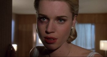 Movie still from “Femme Fatale” (2002), directed by Brian De Palma – A woman's face in a room; Close Up shot, Low angle