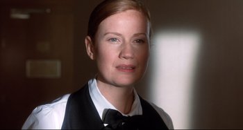 Movie still from “Femme Fatale” (2002), directed by Brian De Palma – A person wearing a vest and bow tie; Close Up shot, Low angle