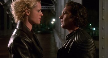 Movie still from “Femme Fatale” (2002), directed by Brian De Palma – A man and a woman standing next to each other; Close Up shot, Low angle