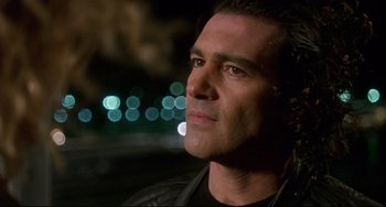 Movie still from “Femme Fatale” (2002), directed by Brian De Palma – A person wearing a black jacket; Close Up shot, Low angle