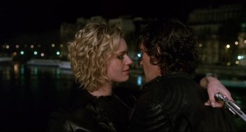 Movie still from “Femme Fatale” (2002), directed by Brian De Palma – A man and a woman in leather jackets face each other; Close Up shot, Over the shoulder angle