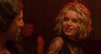 Movie still from “Femme Fatale” (2002), directed by Brian De Palma – A woman in a black lace dress and a man in a red jacket; Close Up shot, Over the shoulder angle