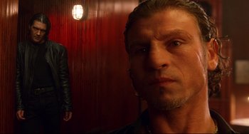 Movie still from “Femme Fatale” (2002), directed by Brian De Palma – A person wearing a leather jacket; Close Up shot, Low angle