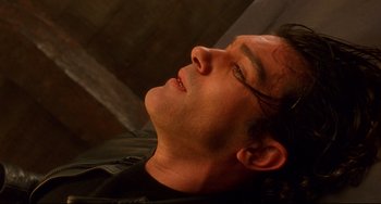 Movie still from “Femme Fatale” (2002), directed by Brian De Palma – A person laying down with his eyes closed; Close Up shot, Overhead angle