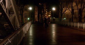 Movie still from “Femme Fatale” (2002), directed by Brian De Palma – A man walking across a bridge at night; Extreme Wide shot, High angle