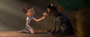 Movie still from “Ferdinand” (2017), directed by Carlos Saldanha – A little girl sitting on the ground next to a cow; Medium shot, High angle
