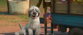 Movie still from “Ferdinand” (2017), directed by Carlos Saldanha – A dog sitting next to a person in a yard; Medium shot, Over the shoulder angle