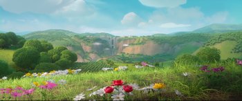 Movie still from “Ferdinand” (2017), directed by Carlos Saldanha – A bunch of flowers in the grass near a waterfall; Extreme Wide shot, High angle
