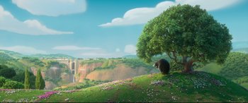 Movie still from “Ferdinand” (2017), directed by Carlos Saldanha – An animal is standing on a hill near a tree; Extreme Wide shot, Low angle