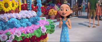 Movie still from “Ferdinand” (2017), directed by Carlos Saldanha – A woman standing in front of a bunch of colorful flowers; Medium shot, Over the shoulder angle