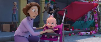 Movie still from “Ferdinand” (2017), directed by Carlos Saldanha – A woman holding a baby in a pink stroller; Medium shot, Over the shoulder angle