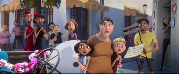 Movie still from “Ferdinand” (2017), directed by Carlos Saldanha – A group of people standing next to each other in front of a building; Medium shot, Over the shoulder angle