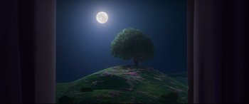 Movie still from “Ferdinand” (2017), directed by Carlos Saldanha – A tree on top of a grassy hill under a full moon at night; Extreme Wide shot, High angle