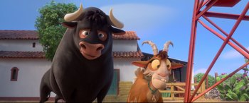 Movie still from “Ferdinand” (2017), directed by Carlos Saldanha – A bull and a goat standing next to each other in front of a building; Medium shot, Low angle