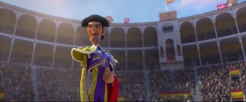 Movie still from “Ferdinand” (2017), directed by Carlos Saldanha – A cartoon character is wearing a hat and holding a mask in front of an audience; Medium shot, Low angle