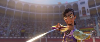 Movie still from “Ferdinand” (2017), directed by Carlos Saldanha – A man holding a pair of scissors in front of an audience; Medium shot, Low angle