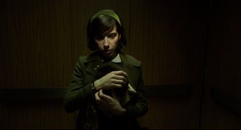 Movie still from “The Shape of Water” (2017), directed by Guillermo del Toro – A woman holding a cat while wearing a green head scarf; Close Up shot, Overhead angle