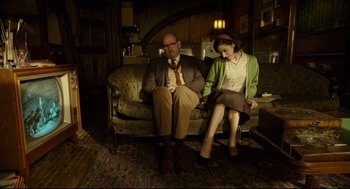 Movie still from “The Shape of Water” (2017), directed by Guillermo del Toro – A man and a woman sitting on a couch in a living room; Medium shot, High angle