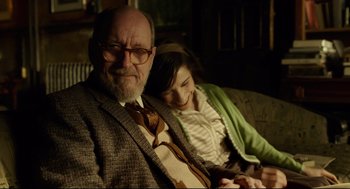 Movie still from “The Shape of Water” (2017), directed by Guillermo del Toro – An older man sitting next to a young girl; Medium shot, Over the shoulder angle