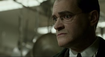 Movie still from “The Shape of Water” (2017), directed by Guillermo del Toro – An older man wearing glasses and wearing a suit; Close Up shot, Over the shoulder angle