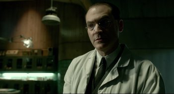 Movie still from “The Shape of Water” (2017), directed by Guillermo del Toro – A man in a white lab coat and a tie; Close Up shot, Low angle