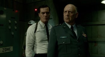 Movie still from “The Shape of Water” (2017), directed by Guillermo del Toro – Two men standing next to each other in uniform; Medium shot, Low angle