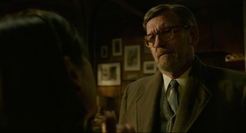 Movie still from “The Shape of Water” (2017), directed by Guillermo del Toro – An older man wearing a suit and tie talking to a younger man; Close Up shot, Over the shoulder angle