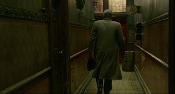 Movie still from “The Shape of Water” (2017), directed by Guillermo del Toro – A man walking down the hall of a building; Wide shot, Over the shoulder angle