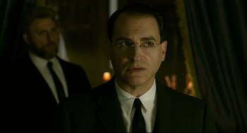 Movie still from “The Shape of Water” (2017), directed by Guillermo del Toro – A person wearing a suit and tie; Close Up shot, Over the shoulder angle