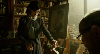Movie still from “The Shape of Water” (2017), directed by Guillermo del Toro – A woman is painting a portrait of a man; Medium shot, Low angle