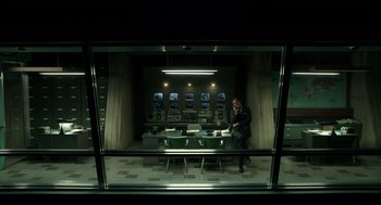 Movie still from “The Shape of Water” (2017), directed by Guillermo del Toro – A man sitting at a table in front of a window; Wide shot, Low angle