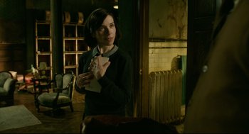 Movie still from “The Shape of Water” (2017), directed by Guillermo del Toro – A woman standing in a room holding a paper; Medium shot, Over the shoulder angle