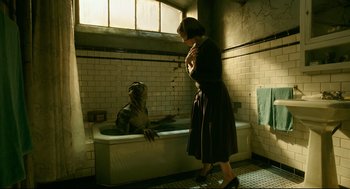Movie still from “The Shape of Water” (2017), directed by Guillermo del Toro – A woman standing next to a bath tub in a bathroom; Medium shot, High angle