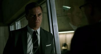 Movie still from “The Shape of Water” (2017), directed by Guillermo del Toro – A man in a suit and a tie; Close Up shot, Over the shoulder angle