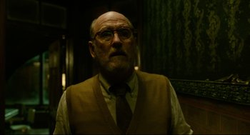 Movie still from “The Shape of Water” (2017), directed by Guillermo del Toro – An older man wearing glasses and a tie; Medium shot, Low angle