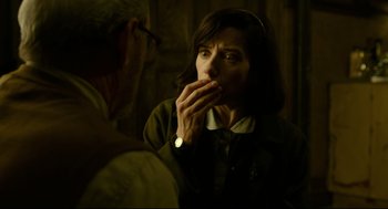 Movie still from “The Shape of Water” (2017), directed by Guillermo del Toro – A woman is looking in the mirror while holding her hand to her mouth; Close Up shot, Over the shoulder angle