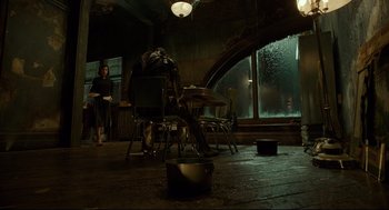 Movie still from “The Shape of Water” (2017), directed by Guillermo del Toro – A group of people sitting at a table in front of a window; Wide shot, High angle