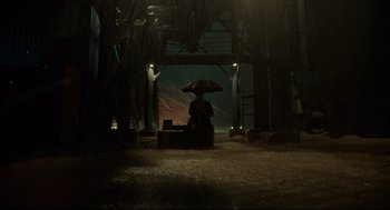 Movie still from “The Shape of Water” (2017), directed by Guillermo del Toro – A person holding an umbrella in a dark room; Extreme Wide shot, Low angle