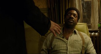 Movie still from “The Shape of Water” (2017), directed by Guillermo del Toro – A man sitting in front of another man with his hand on his shoulder; Close Up shot, High angle