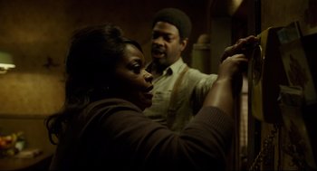 Movie still from “The Shape of Water” (2017), directed by Guillermo del Toro – A woman standing next to a man in a room; Medium shot, Over the shoulder angle